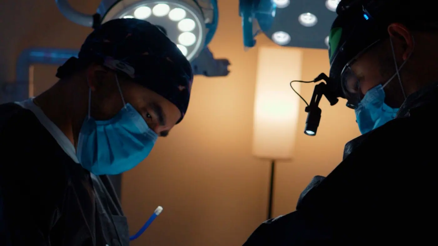 Dr. Rios and his clinical team performing a dental procedure under surgical lighting.
