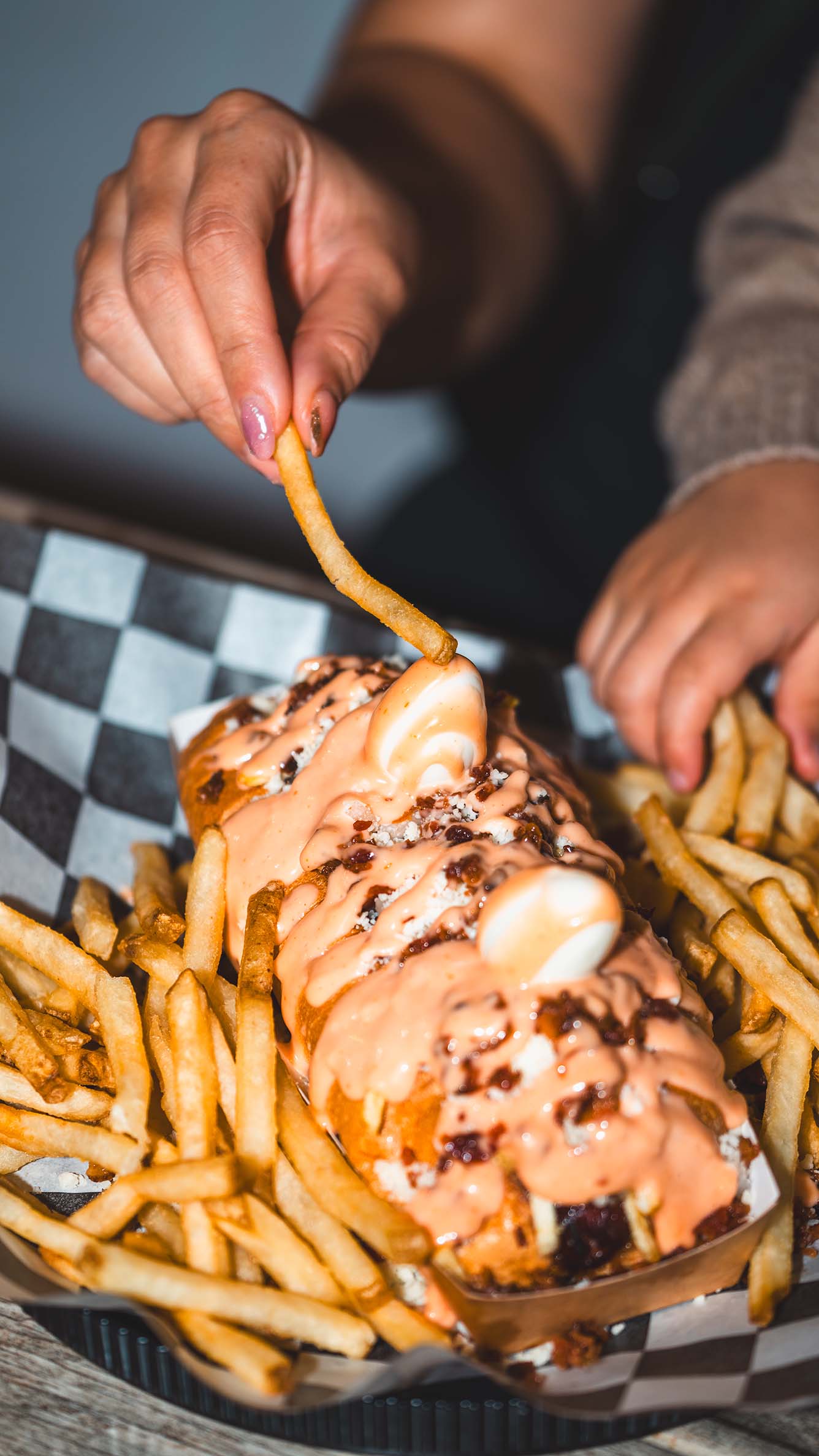 Loaded fries and hot dogs captured during a candid dining moment.