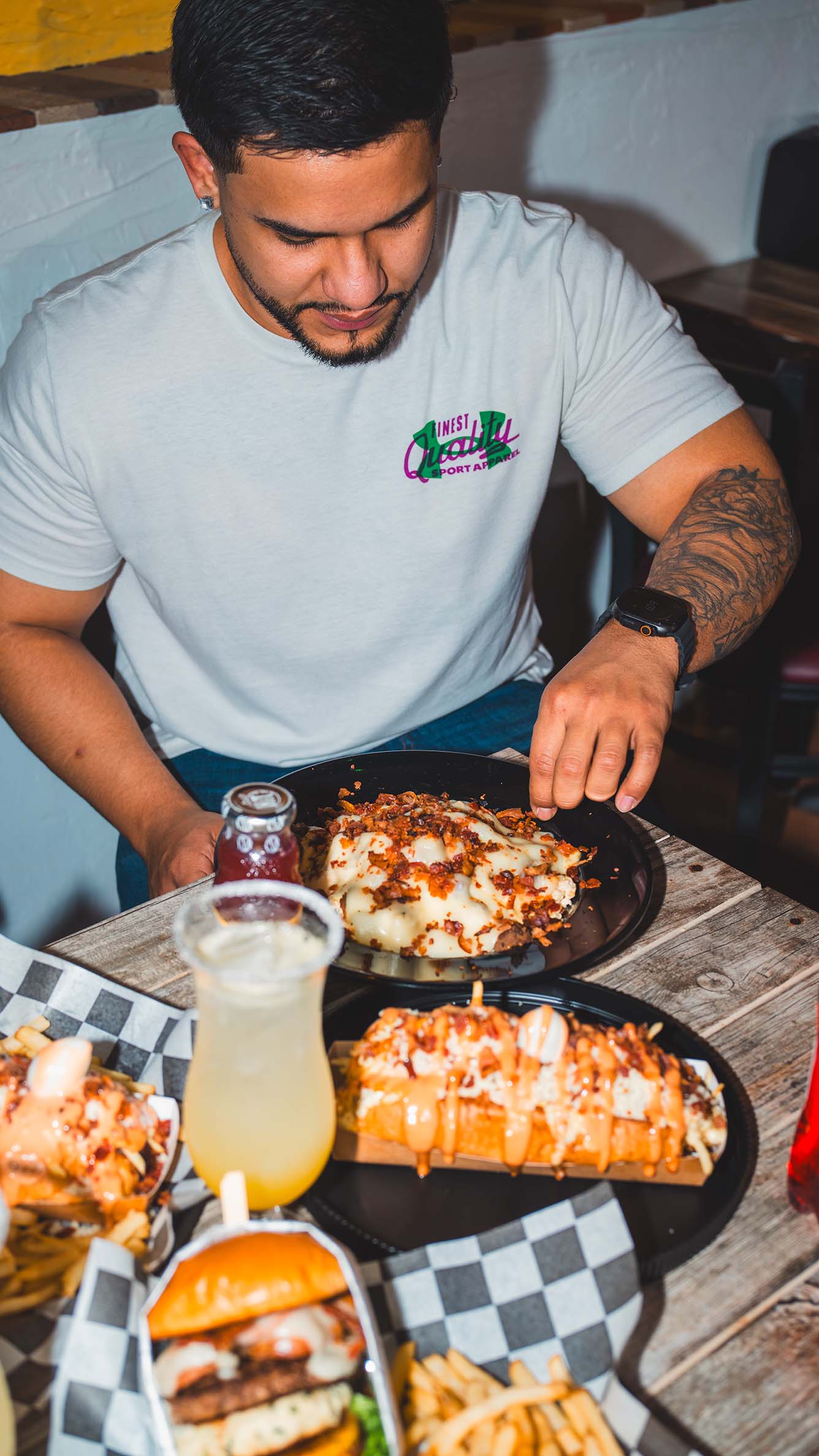 Restaurant guest enjoying a fully loaded plate in a lifestyle scene.