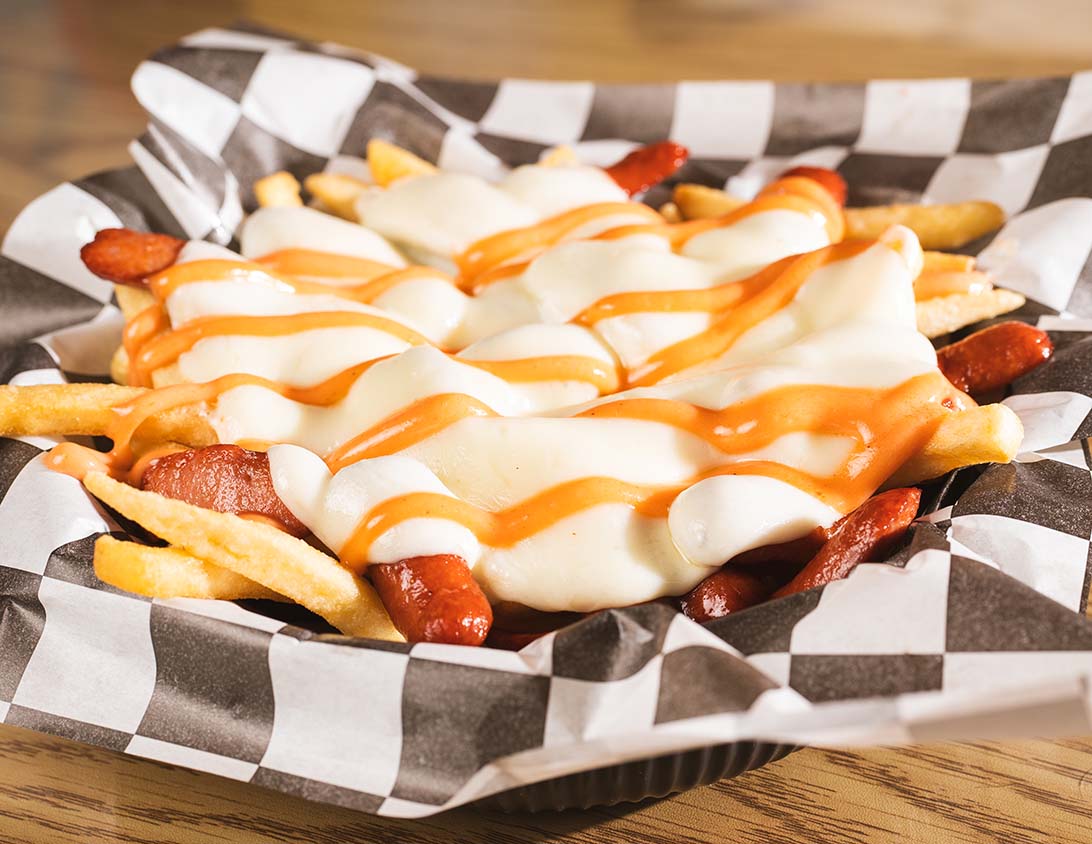 Loaded fries topped with sausage, melted cheese, and signature sauce.